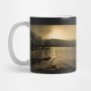 The sun sets over a misty Derwentwater Mug